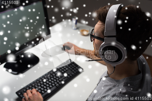 Image of man in headset playing computer video game