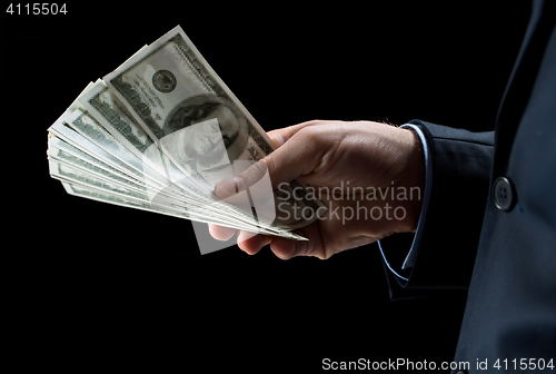 Image of close up of businessman hands holding money