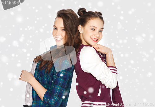 Image of happy smiling pretty teenage girls over snow