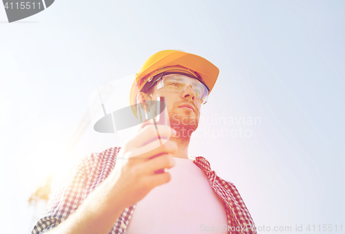 Image of builder in hardhat with radio