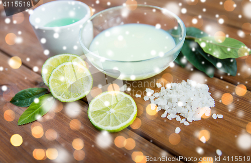 Image of body lotion, cream and salt on wood