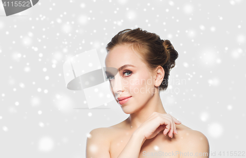 Image of beautiful young woman face over snow