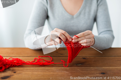 Image of woman hands knitting with needles and yarn