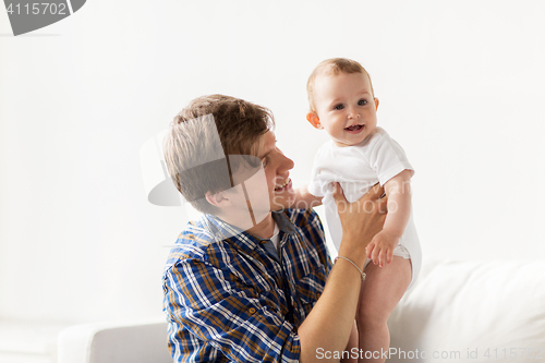 Image of happy young father with little baby at home