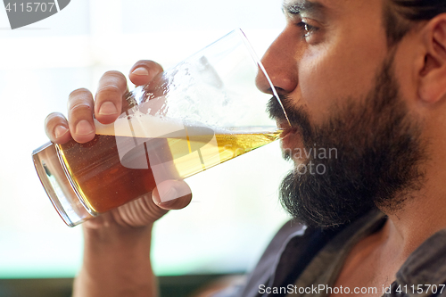 Image of close up of man drinking beer at bar or pub