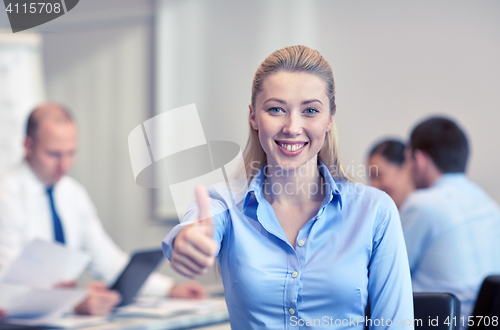 Image of group of smiling businesspeople meeting in office