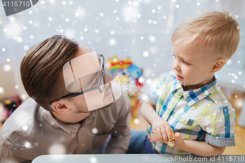 Image of father and son playing with ball clay at home