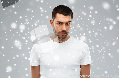 Image of young man portrait over snow