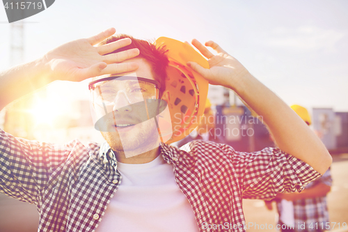 Image of group of builders in hardhats outdoors