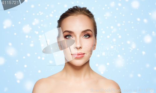 Image of beautiful young woman face over snow