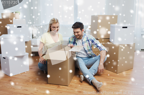 Image of smiling couple with big boxes moving to new home