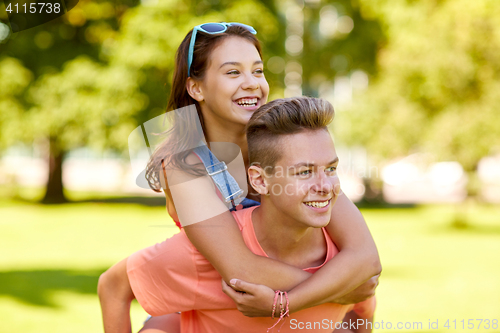 Image of happy teenage couple having fun at summer park