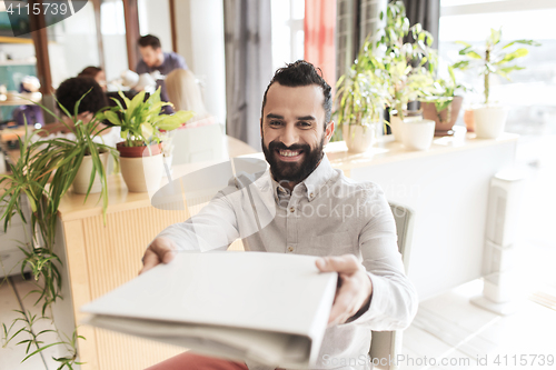 Image of happy creative male office worker with folfer