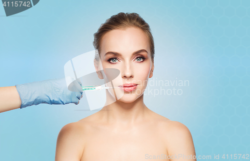 Image of woman face and hand with syringe making injection