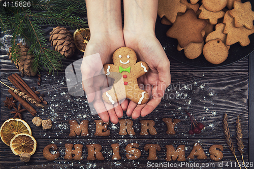 Image of Woman hands keep ginger cookies