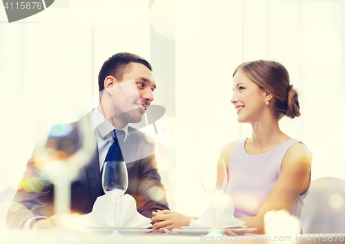 Image of smiling couple looking at each other at restaurant