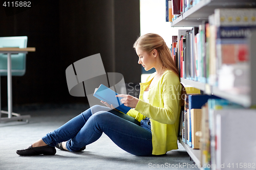 Image of high school student girl reading book at library