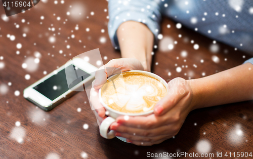 Image of close up of woman with smartphone and coffee