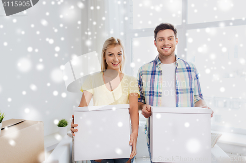 Image of smiling couple with big boxes moving to new home