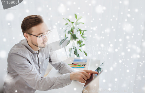 Image of happy creative male office worker with tablet pc