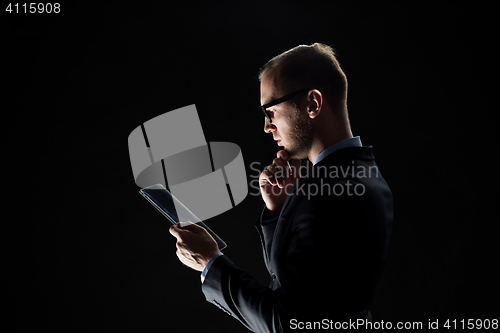 Image of close up of businessman with transparent tablet pc