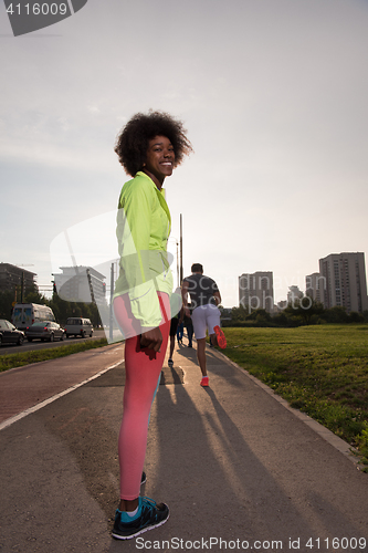 Image of Portrait of sporty young african american woman running outdoors