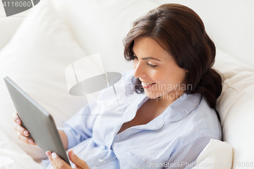 Image of happy pregnant woman with tablet pc at home