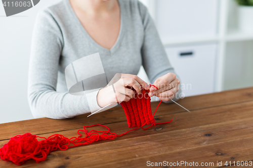 Image of woman hands knitting with needles and yarn