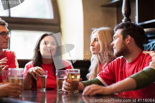 Image of fans or friends watching football at sport bar