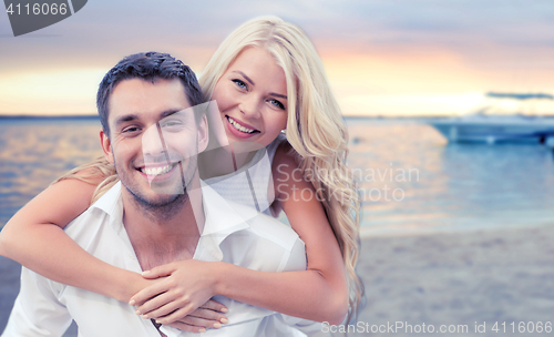 Image of happy couple having fun over beach background