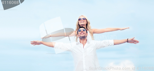 Image of couple holding hands up at sea side