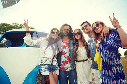 Image of hippie friends over minivan car showing peace sign