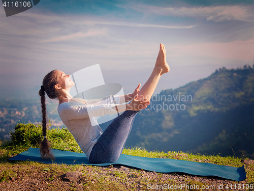 Image of Woman doing Ashtanga Vinyasa Yoga asana Navasana - boat pose