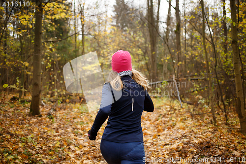 Image of Woman in pink hat jogging