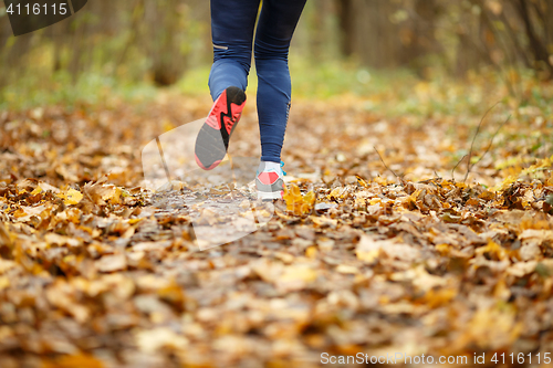 Image of Girl in sneakers running autumn