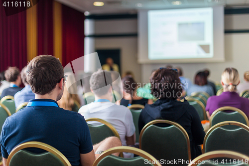 Image of Audience in lecture hall participating at business conference.