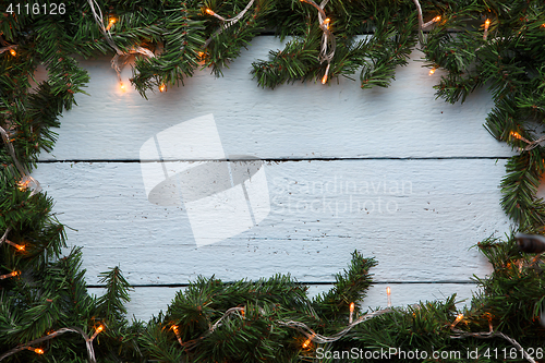 Image of Spruce branches on wooden background