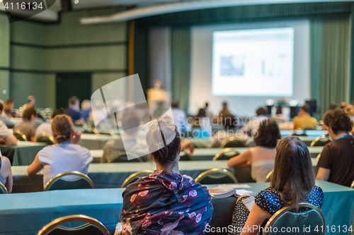 Image of Audience in lecture hall participating at business conference.