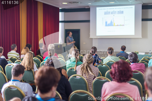 Image of Audience in lecture hall participating at business conference.