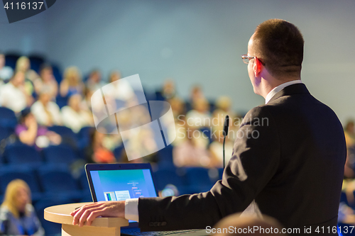 Image of Public speaker giving talk at business event.