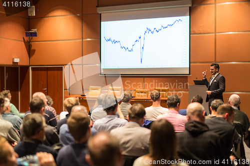 Image of Business speaker giving a talk in conference hall.