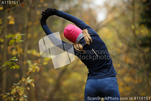 Image of Young woman in autumn park