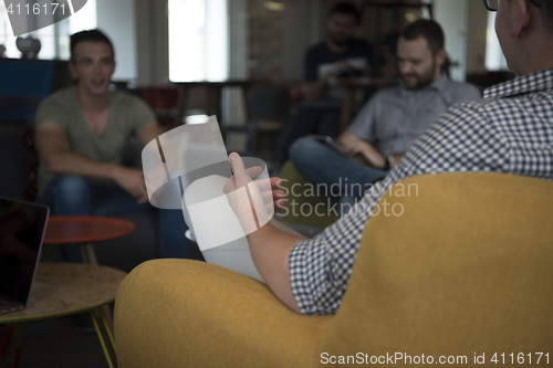 Image of close up of male hands while working in modern office