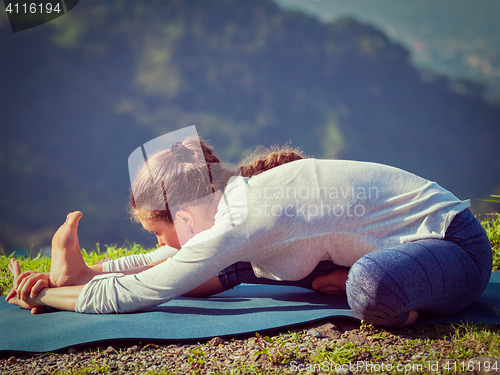 Image of Woman doing Ashtanga Vinyasa yoga Janu Sirsasana A asana stretch