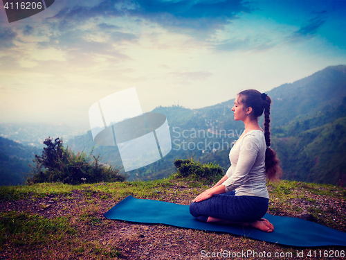 Image of Woman doing Yoga asana Virasana Hero pose