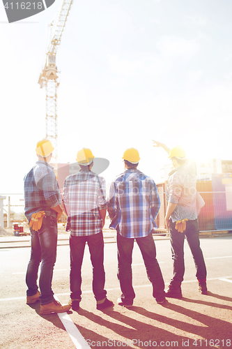 Image of group of builders in hardhats outdoors