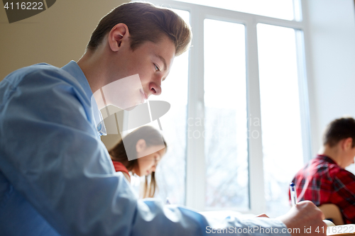 Image of group of students with books writing school test