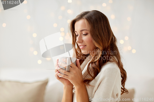 Image of happy woman with cup of tea or coffee at home