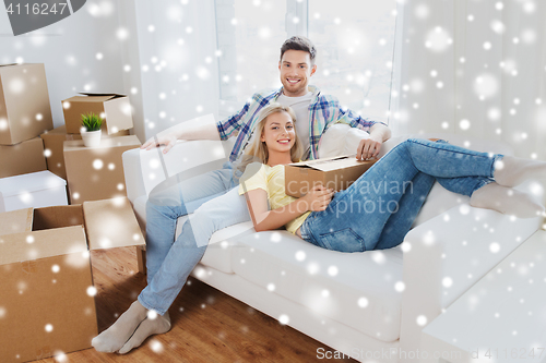 Image of happy couple with big cardboard boxes at new home