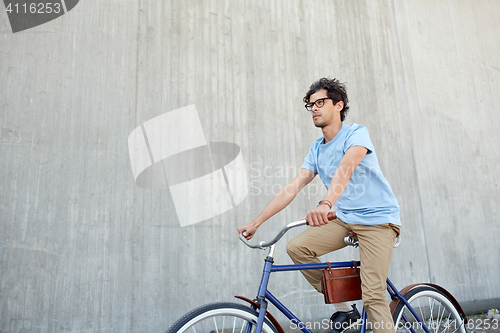 Image of young hipster man riding fixed gear bike